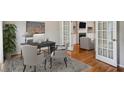 Bright office space with hardwood floors, a desk, and a view into a cozy living area at 4284 Windy Gap Nw Ct, Kennesaw, GA 30144
