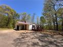 A well-maintained single-story home featuring a covered carport and a welcoming front porch at 5130 English Dr, Cumming, GA 30041