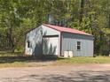 View of the detached garage with metal siding, providing ample space for parking and storage at 5130 English Dr, Cumming, GA 30041