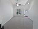 Bright living room with vaulted ceilings, neutral tones, large window for natural light, and gray carpeting at 5763 Mitchell Chase Trl, Mableton, GA 30126