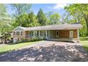 Traditional brick home featuring a carport and driveway at 120 Westwood Nw Dr, Marietta, GA 30064