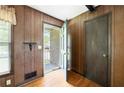 View of the foyer with wood paneling and access to front porch at 120 Westwood Nw Dr, Marietta, GA 30064