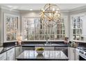 Bright kitchen with granite countertops and island. Features stainless appliances and large windows overlooking the yard at 2125 Fairfax Dr, Alpharetta, GA 30009