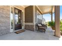 Covered front porch with seating, stone pillars and charming details, perfect for enjoying the outdoors at 347 Woodridge Pass, Canton, GA 30114