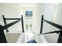 Modern staircase showcasing high ceilings, a statement window, and stylish black metal railings at 3554 Cherry Bloom Way, Decatur, GA 30034