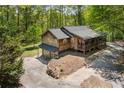 Aerial view of the home with an attached garage and extensive porch, nestled in trees at 4288 Post Rd, Winston, GA 30187
