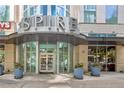 Upscale building entrance with revolving doors, planters, and clear signage at the Spire Condominiums at 860 Peachtree Ne St # 1010, Atlanta, GA 30308