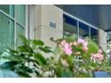 Modern building exterior showing the address number, large windows, and manicured landscaping at 860 Peachtree Ne St # 1010, Atlanta, GA 30308