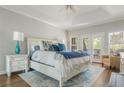 Serene primary bedroom with a tray ceiling, hardwood floors, a ceiling fan, and private outdoor access at 10575 Wren Ridge Rd, Alpharetta, GA 30022