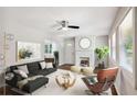 Bright living room with a cozy fireplace, ceiling fan, and modern decor at 1753 Detroit Nw Ave, Atlanta, GA 30314
