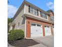 Townhome boasting a two-car garage, brick accents, and neutral siding at 1960 Dakota Nw Dr, Acworth, GA 30101