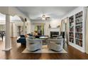 Spacious living room with a fireplace, custom bookshelves, and lots of natural light at 1020 Burton Ne Dr, Atlanta, GA 30329