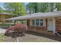 Close up of brick ranch style home with beautiful landscaping and a covered carport at 1093 Lanier Sw Dr, Marietta, GA 30060