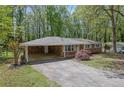 Lovely brick home with carport and landscaping, nestled among mature trees at 1093 Lanier Sw Dr, Marietta, GA 30060