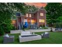 Beautiful backyard featuring a cozy fire pit with ample seating, a slide and trampoline, perfect for outdoor fun at 1116 Dan Johnson Ne Rd, Atlanta, GA 30307