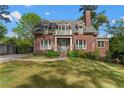 Charming brick home with a manicured front yard, classic white columns, and a welcoming entrance, providing curb appeal at 1116 Dan Johnson Ne Rd, Atlanta, GA 30307