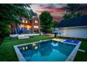Stunning backyard featuring a luxurious swimming pool and hot tub, perfect for outdoor relaxation and entertainment at 1116 Dan Johnson Ne Rd, Atlanta, GA 30307