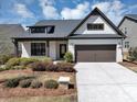 Charming single-Gathering home featuring a two-car garage, attractive landscaping, and classic white painted brick at 348 Ellington Dr, Canton, GA 30115