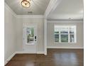 Spacious foyer featuring hardwood floors, neutral paint, a glass paneled front door and large window at 348 Ellington Dr, Canton, GA 30115
