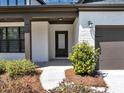 Inviting front entrance with classic white painted brick, covered porch, and well-manicured landscaping at 348 Ellington Dr, Canton, GA 30115