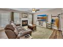 Comfortable living room with a fireplace, modern TV, plush seating, and stylish decor for a cozy atmosphere at 373 Hidden Creek Ln, Canton, GA 30114