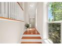 Bright hallway with hardwood floors, large windows, and white trim leading to the main living areas and the upper floor at 1561 Mosaic Way, Smyrna, GA 30080