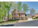 Traditional brick home with a manicured lawn, black shutters, and a welcoming front entrance at 1826 Bedfordshire Ct, Decatur, GA 30033
