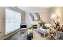 Cozy living room with chairs, decorative fireplace, and natural light from window at 2121 Silva Ct, Conley, GA 30288