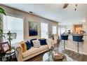 Comfortable living room featuring a sofa, bar stools, modern decor, and natural light at 2121 Silva Ct, Conley, GA 30288
