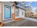Close up of a newly renovated home featuring a vibrant blue door and freshly painted brick at 3460 Fairlane Dr, Atlanta, GA 30331
