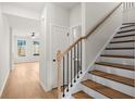 Open staircase with wood steps, black iron spindles, and a natural wood banister at 1016 Rose Dr, Marietta, GA 30060