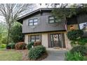 Two-story brick home with a decorative front door, mature trees and lush landscaping at 1039 Smyrna Rd Sw, Conyers, GA 30094