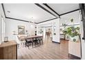 Open-concept dining room with wood floors, neutral walls, and modern lighting at 13070 Tidewater Xing, Alpharetta, GA 30005