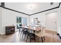 Bright dining room with wood floors, modern lighting, and a large window at 13070 Tidewater Xing, Alpharetta, GA 30005