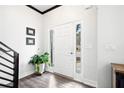 Bright entryway featuring hardwood floors, a white front door with sidelights and clean, white walls at 13070 Tidewater Xing, Alpharetta, GA 30005