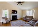 Bright living room showcasing a fireplace, vaulted ceilings, hardwood floors, and plenty of natural light at 195 Woodbridge Dr, Dallas, GA 30157