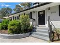 Close up of painted brick home featuring landscaped garden and front door with decorative glass at 2123 Juanita St, Decatur, GA 30032
