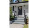 Close up of painted brick home featuring stairs to front door with decorative glass sidelights at 2123 Juanita St, Decatur, GA 30032