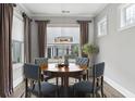 Cozy dining room with ample light from large windows and stylish decor at 26 Hardpan Aly, Marietta, GA 30066
