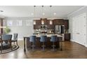 Well-equipped kitchen boasts an island with seating and stainless steel appliances at 26 Hardpan Aly, Marietta, GA 30066