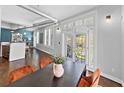 Inviting dining area features hardwood floors, modern lighting, seating for four, and access to a private balcony at 1029 Piedmont Ne Ave # 102, Atlanta, GA 30309