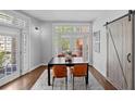 Dining room boasts hardwood floors, a modern light fixture and access to a private balcony at 1029 Piedmont Ne Ave # 102, Atlanta, GA 30309