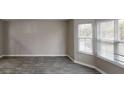 Open living room with gray tile flooring and large windows at 2740 Ashley Downs Ln, Atlanta, GA 30349