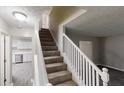 Carpeted staircase featuring a white railing leading to the upper level at 2740 Ashley Downs Ln, Atlanta, GA 30349