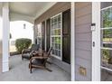 Inviting front porch with cozy seating, offering a relaxing outdoor space with great curb appeal at 4013 Suwanee Place Dr, Suwanee, GA 30024