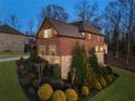 Charming brick home with well-maintained landscaping and stone accents, creating an inviting and picturesque setting at 4538 Sterling Pointe Nw Dr, Kennesaw, GA 30152