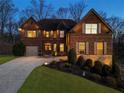 Inviting brick home with a two-car garage, elegant lighting, and a meticulously landscaped front yard, perfect for families at 4538 Sterling Pointe Nw Dr, Kennesaw, GA 30152