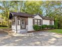 Charming brick home featuring a cozy screened-in porch and a well-kept lawn at 1340 Hawthorne Se Ave, Smyrna, GA 30080