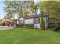 Beautifully landscaped front yard with a charming white brick home at 1340 Hawthorne Se Ave, Smyrna, GA 30080