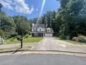 Inviting two-story home with a well-kept lawn, attached two-car garage and mature trees at 3870 Spring Moss Cir, Snellville, GA 30039